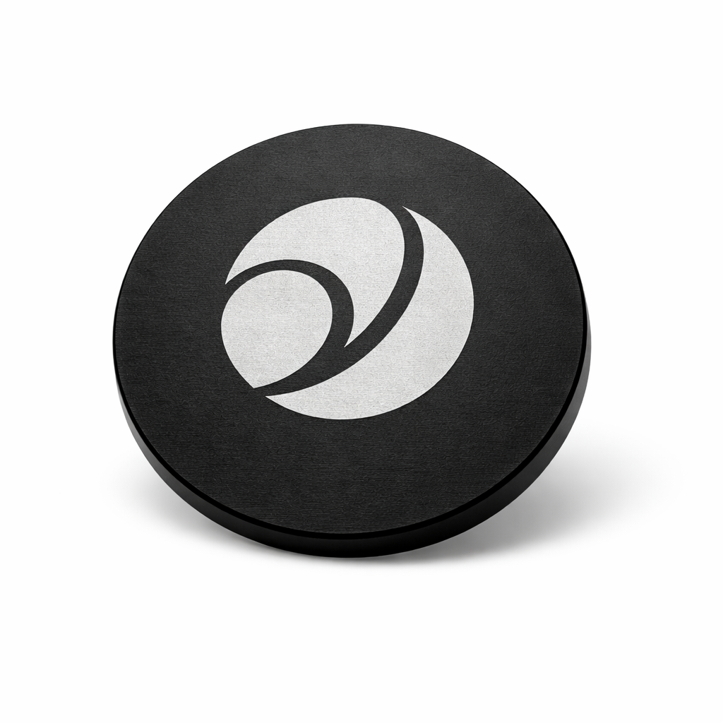 Black circular object with a white logo on a white background